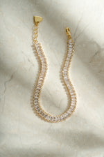 Gold Baguette Tennis Bracelet by Sami Jewels featuring sparkling rectangular-cut gemstones in a sleek, elegant design.