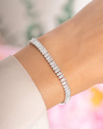 Silver Baguette Tennis Bracelet by Sami Jewels featuring a sleek row of baguette-cut stones on a delicate bracelet.