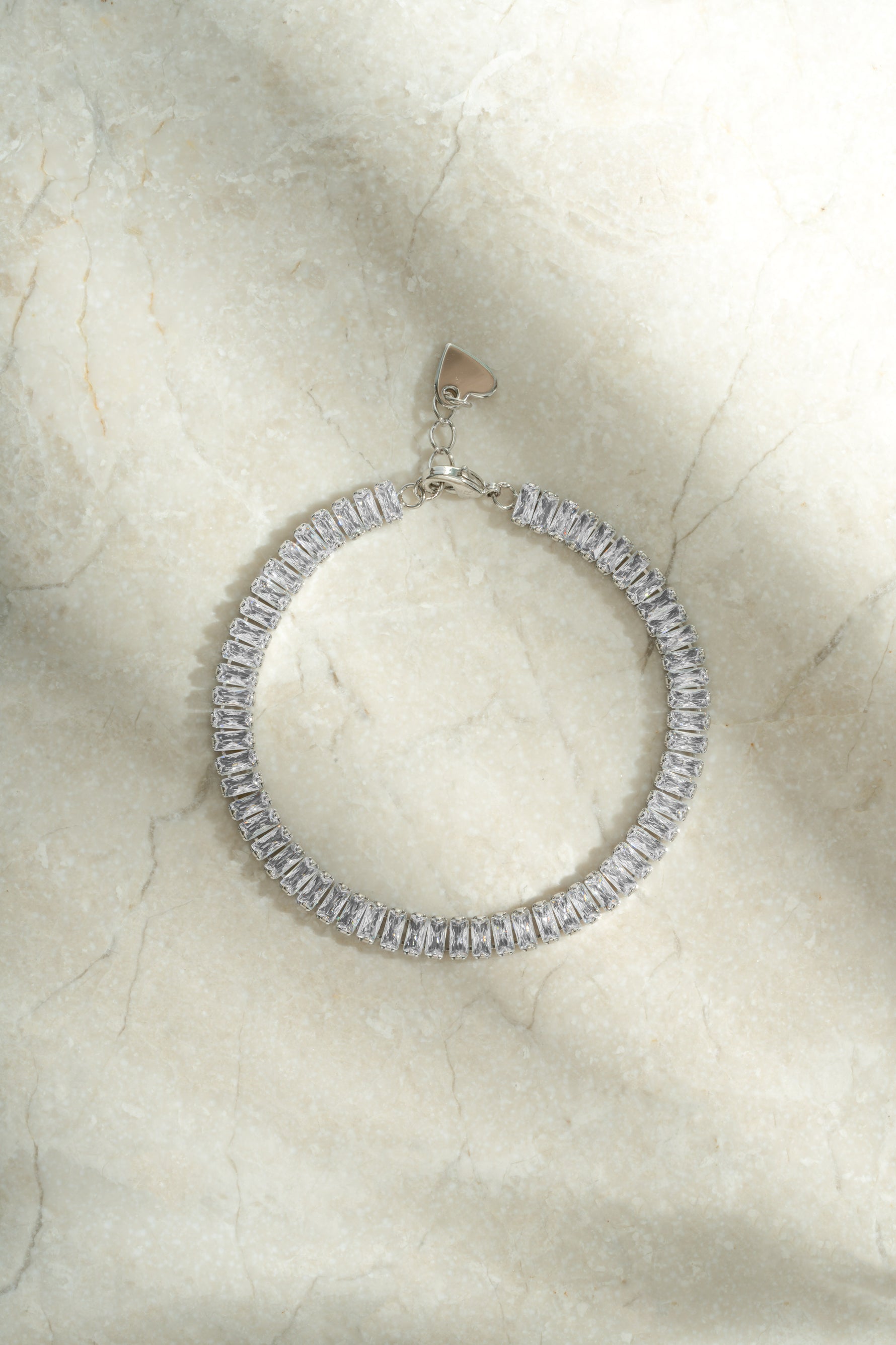 Silver Baguette Tennis Bracelet by Sami Jewels featuring rectangular cut gemstones in a sleek, elegant design.
