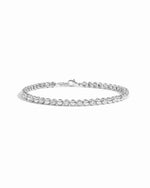 Silver Bead & Bezel Tennis Bracelet by Sami Jewels, featuring sparkling beads on a sleek silver band with a white background.