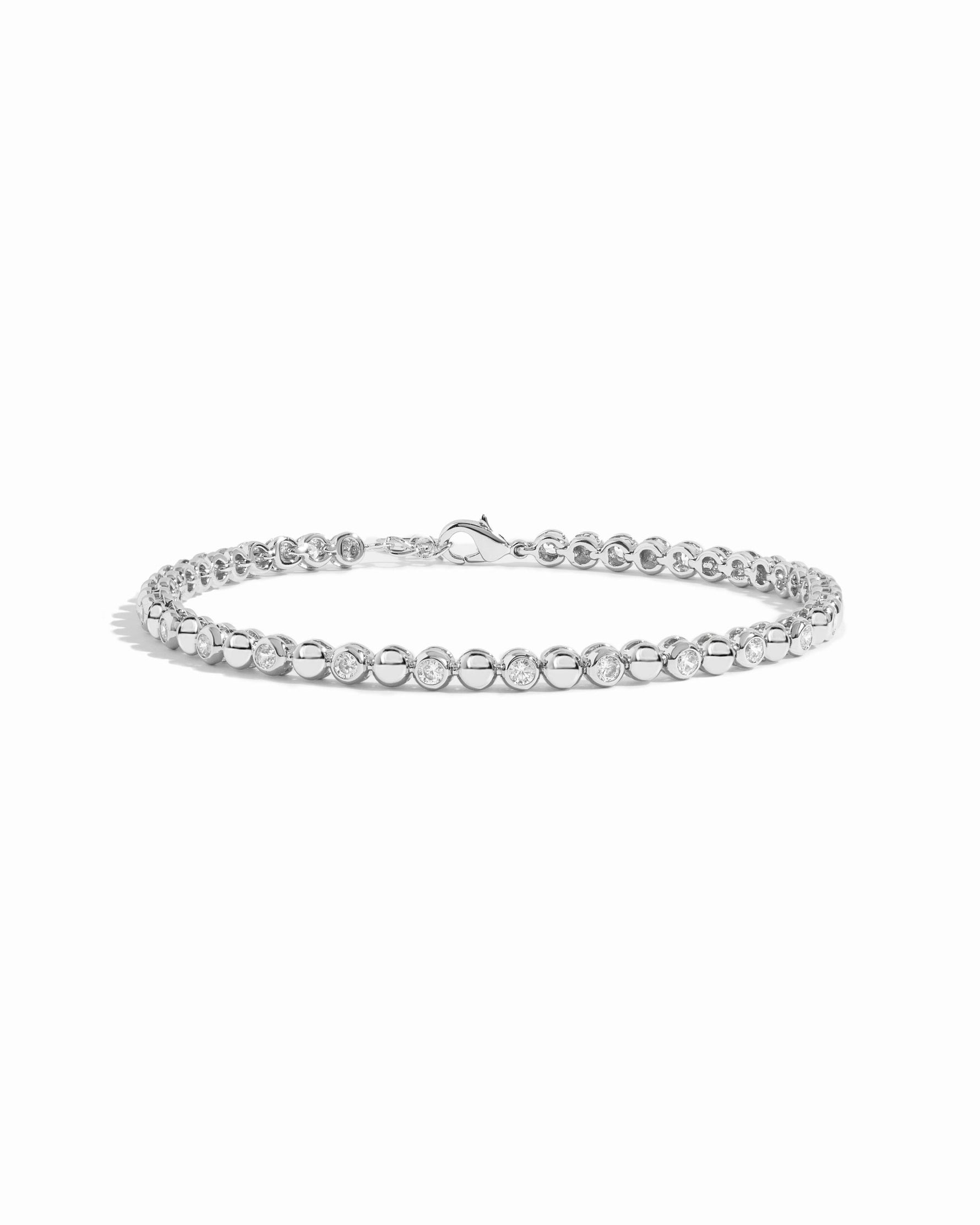 Silver Bead & Bezel Tennis Bracelet by Sami Jewels, featuring sparkling beads on a sleek silver band with a white background.