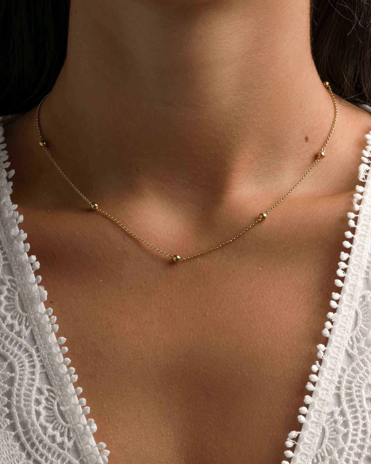 beaded ball necklace in gold on model