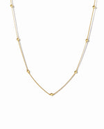 beaded ball necklace in gold on a white background