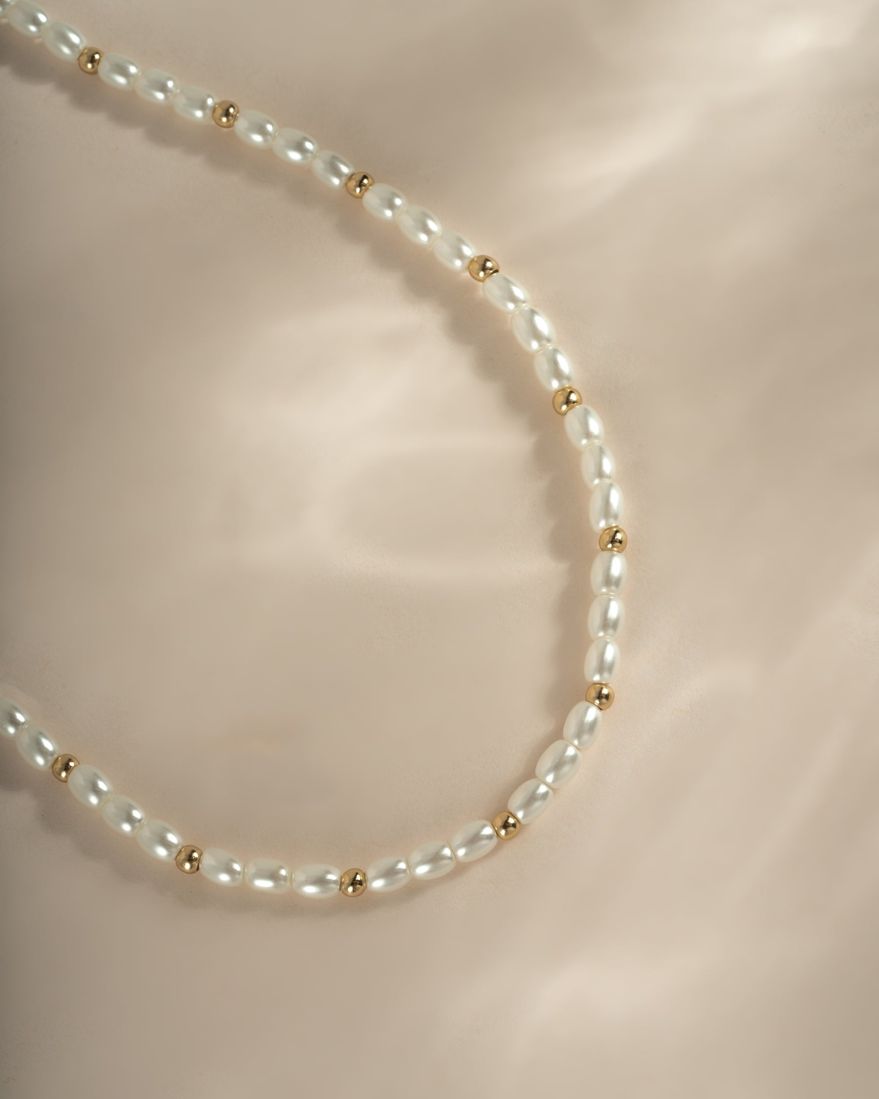 Close-up of Sami Jewels beaded pearl necklace with gold accents, showcasing elegant pearl beads and intricate design.