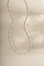 Beaded pearl necklace by Sami Jewels featuring elegant gold accents and a string of lustrous pearls.