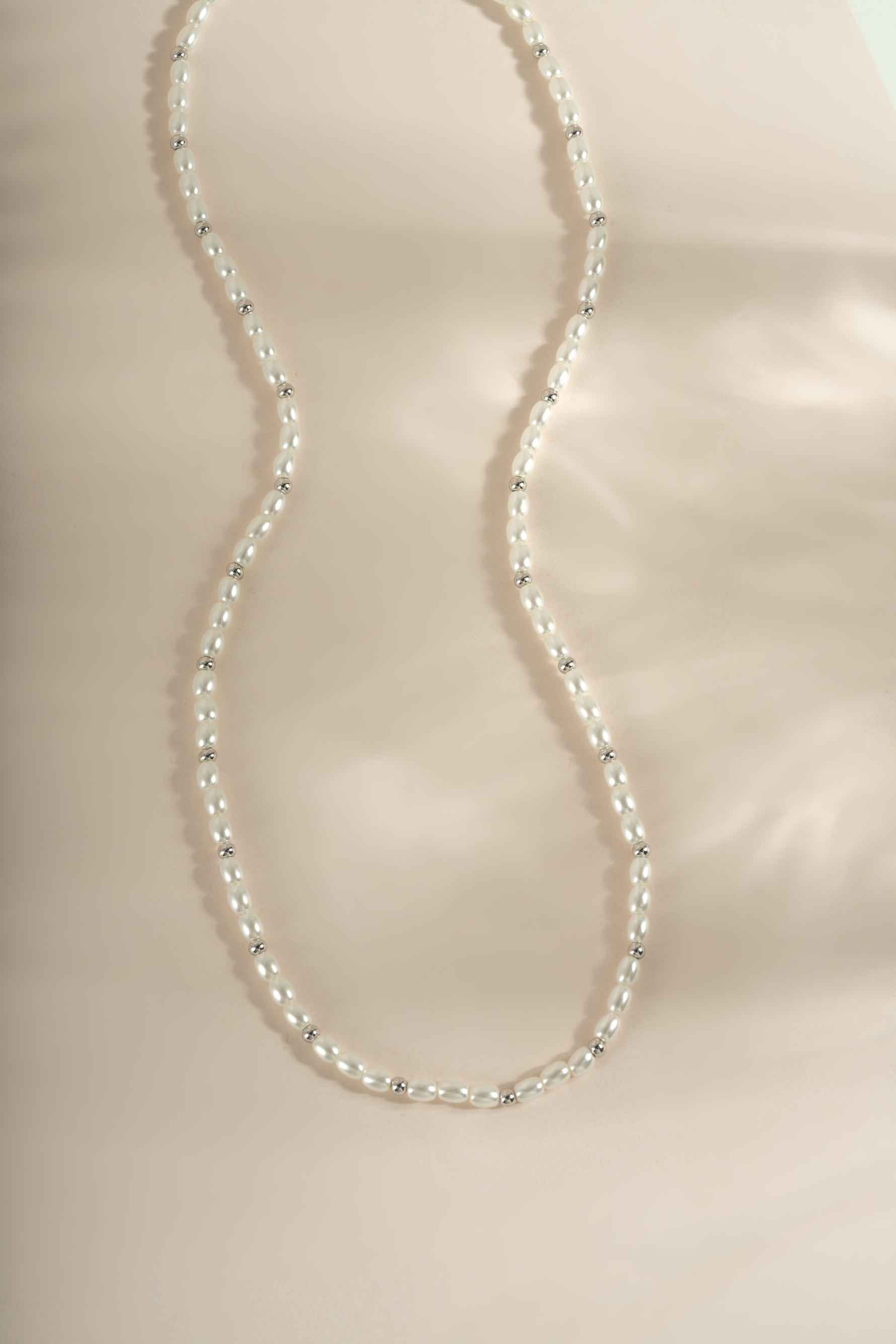 Beaded pearl necklace by Sami Jewels featuring elegant gold accents and a string of lustrous pearls.