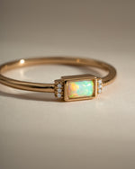 Close-up of Sami Jewels Bezel Baguette Opal Ring in gold, showcasing the bezel setting and rectangular opal gemstone.