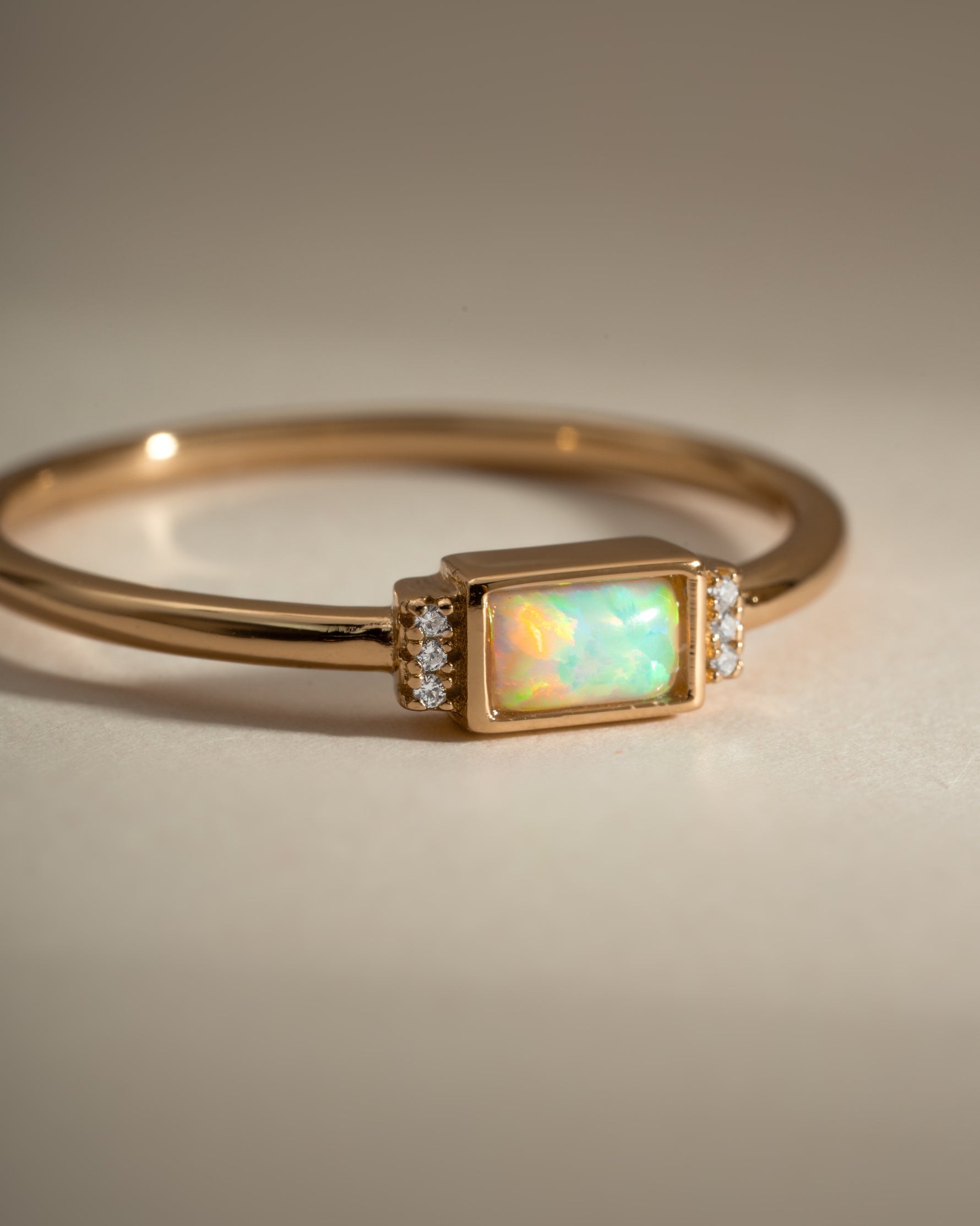Close-up of Sami Jewels Bezel Baguette Opal Ring in gold, showcasing the bezel setting and rectangular opal gemstone.