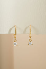 Gold Sami Jewels Bezel Charm Huggie earrings with detailed front view showcasing their elegant design.