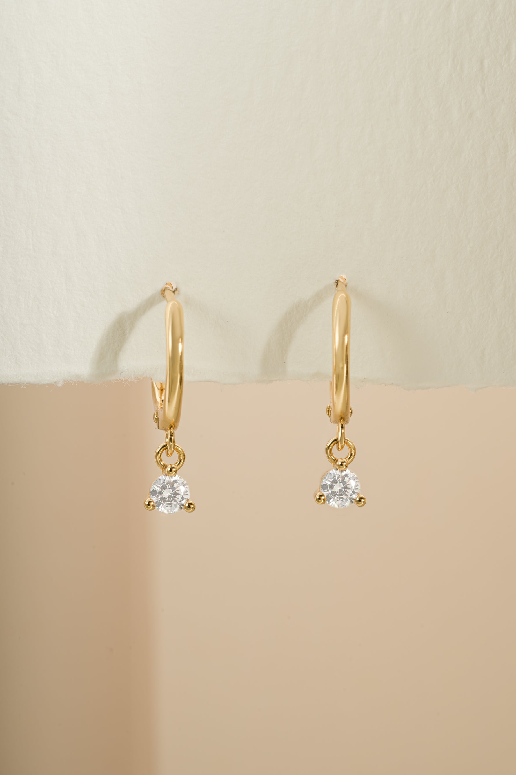 Gold Sami Jewels Bezel Charm Huggie earrings with detailed front view showcasing their elegant design.
