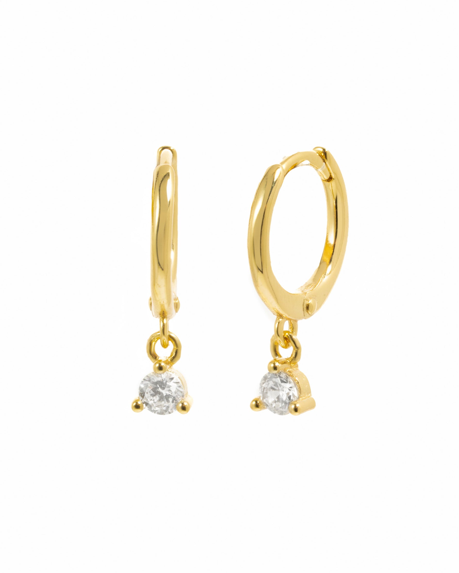 Gold bezel charm huggie earrings from Sami Jewels, featuring sleek design on a white background.