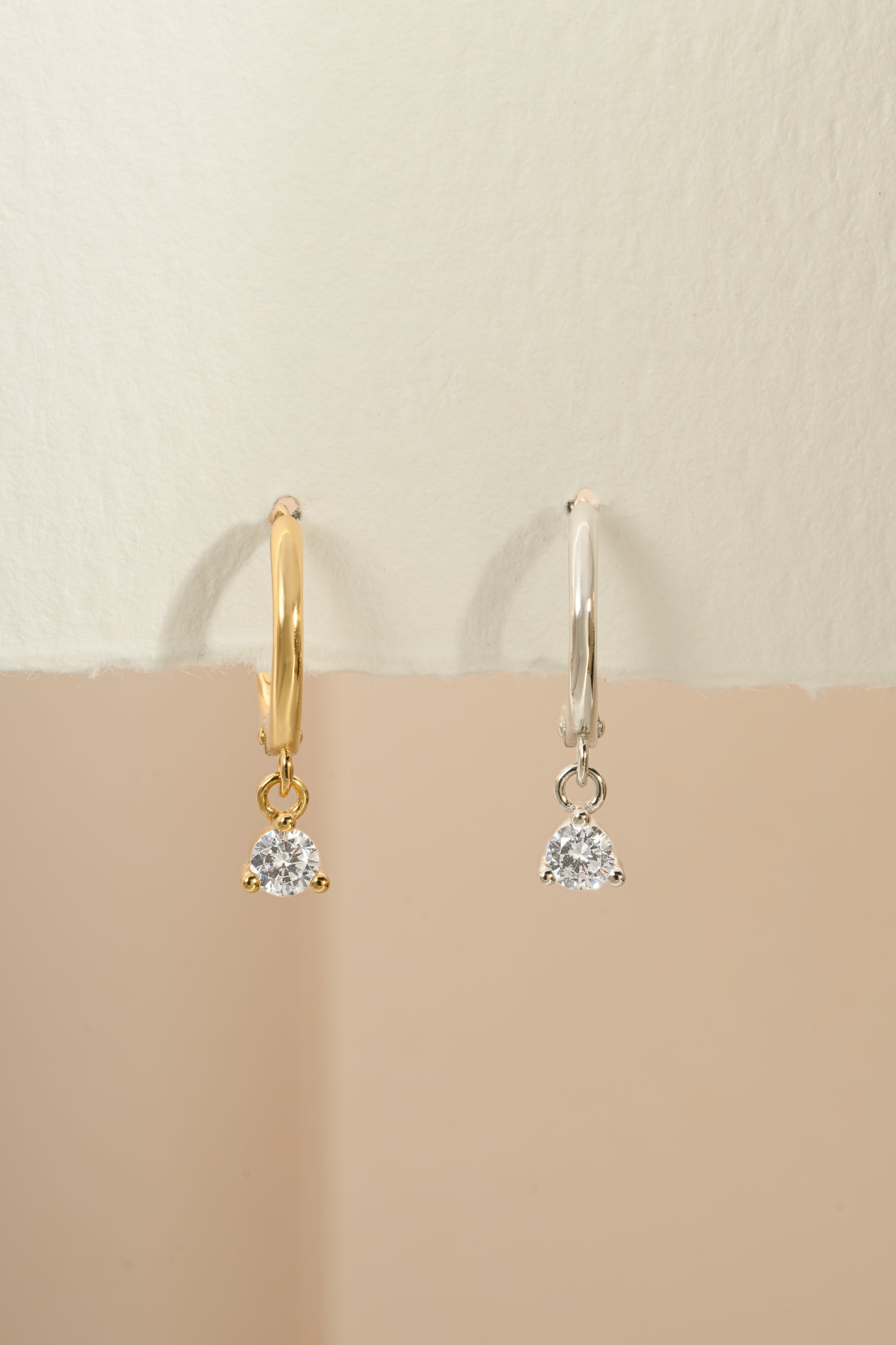 Gold and sterling silver bezel charm huggie earrings by Sami Jewels featuring small hoop design with decorative charms.