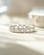 Sterling silver Bezel Emerald Cut Eternity Band ring by Sami Jewels, featuring alternating emerald-cut stones around the band.