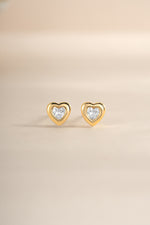 Gold bezel heart stud earrings by Sami Jewels, front view showing delicate heart-shaped design and secure stud backing.