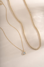 Golden round bezel necklace bundle by Sami Jewels featuring multiple elegant, dainty necklaces on display.