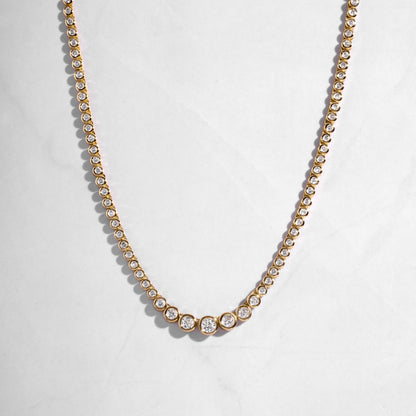 gold necklace set in a diamond tennis chain. 