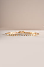 Close-up of Sami Jewels bezeled baguette tennis bracelet in gold, showcasing the elegant rectangular gemstone settings.