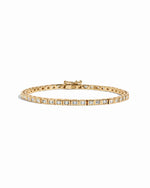 Gold Bezeled Baguette Tennis Bracelet by Sami Jewels, featuring rectangular white gemstones on a sleek bracelet.
