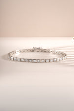 Close-up of Sami Jewels silver bezeled baguette tennis bracelet showcasing sparkling rectangular gemstones and elegant design.