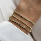 Model wearing 1.75mm Tennis Bracelet layered with dainty gold bangles, highlighting its stylish and elegant appearance.