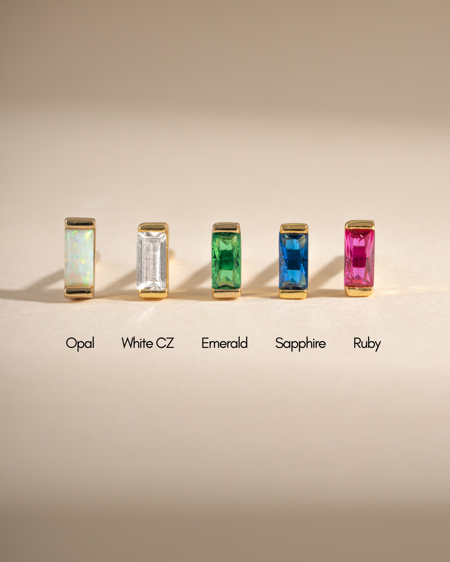 White cubic zirconia baguette stud earrings by Sami Jewels, showcasing elegant jewelry with sparkling gemstone details.