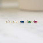 picture showcasing birthstone earrings including white cubic zirconia stud earrings, opal small stud earrings, sapphire earrings, emerald earrings, and ruby dainty earrings
