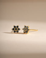 Black flower stud earrings by Sami Jewels featuring gold accents, small floral design perfect for everyday wear.