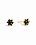 Black flower stud earrings by Sami Jewels, featuring gold accents on a white background.