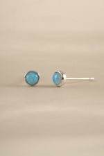 Blue Opal Stud Earrings by Sami Jewels featuring sterling silver settings and vibrant blue opal gemstones.