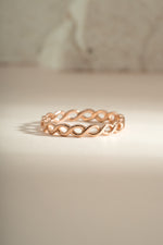Rose gold braided eternity ring by Sami Jewels, showcasing a continuous braided design on a stylish ring.