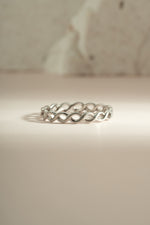 Sterling silver braided eternity ring by Sami Jewels, showcasing a continuous woven design perfect for elegant jewelry.