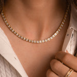 Bridal tennis necklace plated in 14k gold from Sami Jewels, worn on woman model.