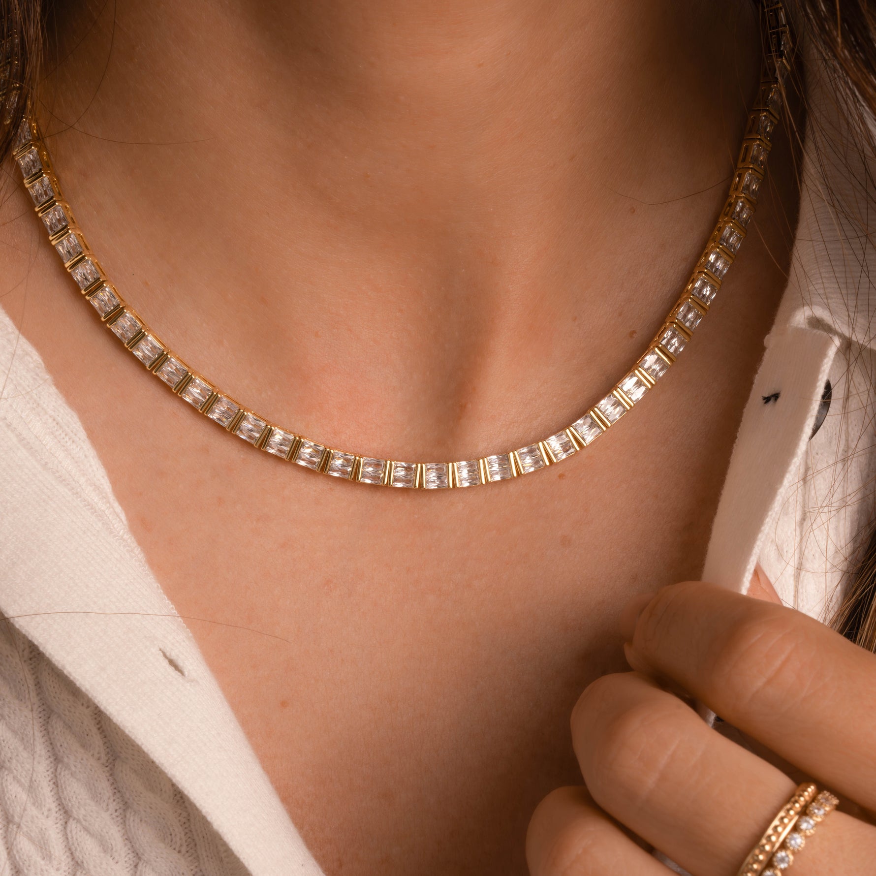 Bridal tennis necklace plated in 14k gold from Sami Jewels, worn on woman model.