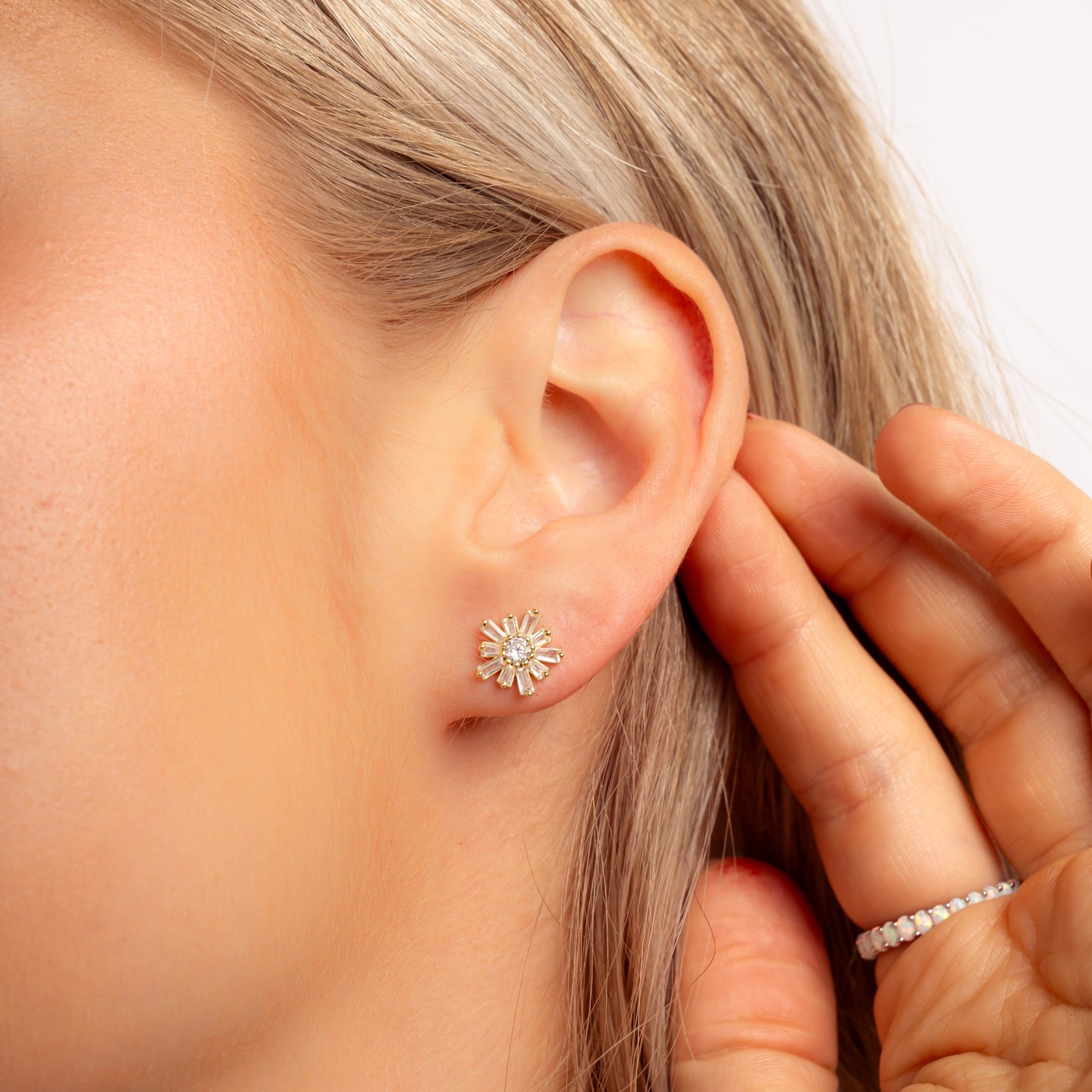 model wearing diamond flower stud earrings