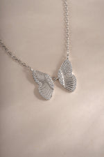 Sterling silver butterfly necklace by Sami Jewels, close-up showing detailed butterfly pendant on a delicate chain.