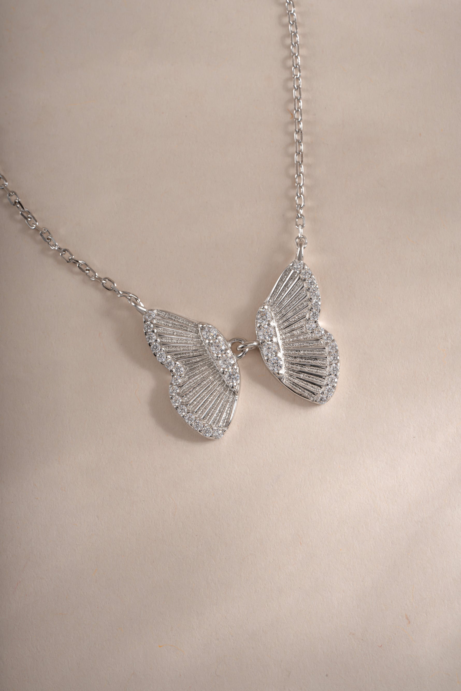 Sterling silver butterfly necklace by Sami Jewels, close-up showing detailed butterfly pendant on a delicate chain.