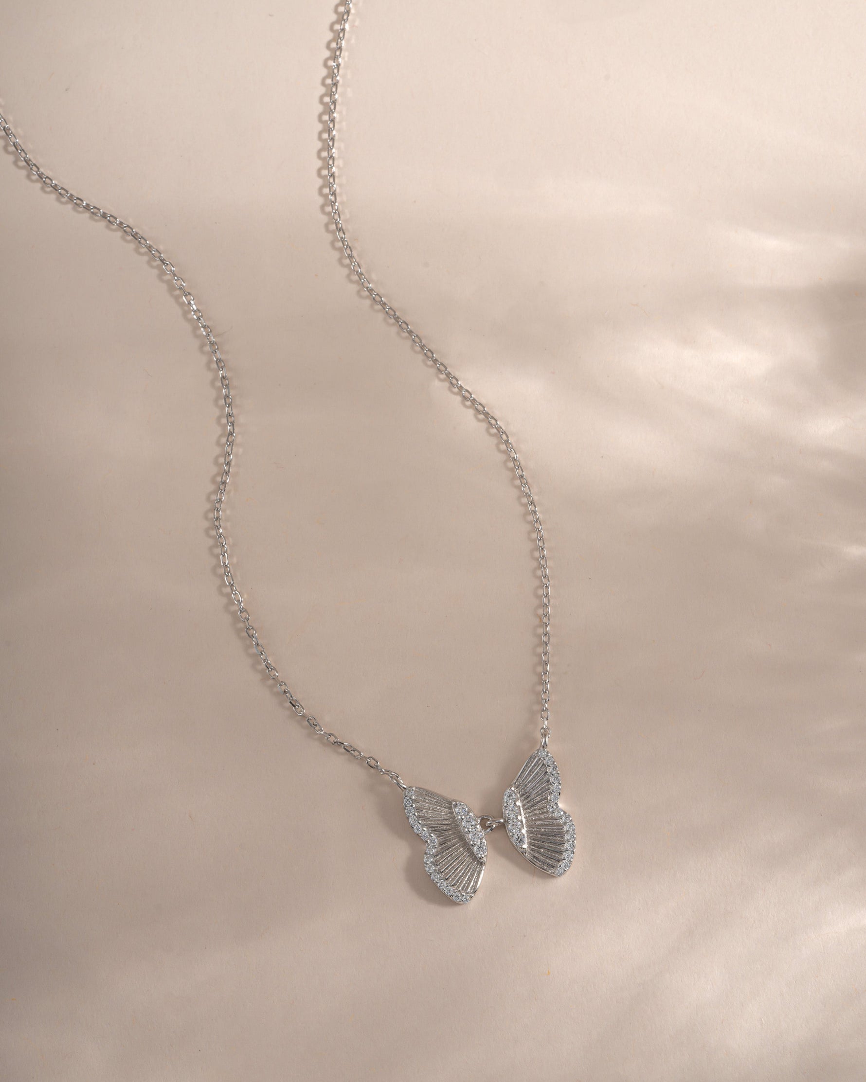 Sterling silver butterfly necklace from Sami Jewels with detailed butterfly pendant on a delicate chain.