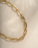 Close-up of a gold chain link necklace from Sami Jewels, showcasing the intricate chain link design.