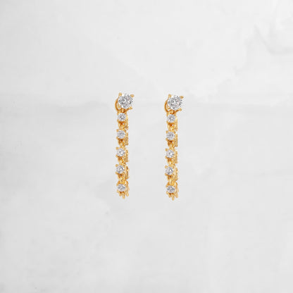 Close-up of gold chain earrings with a smooth, polished texture and delicate hanging links, perfect as gift for her.