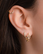 Gold chain link hoop earrings by Sami Jewels, small size, featuring a stylish chain link design on a model.