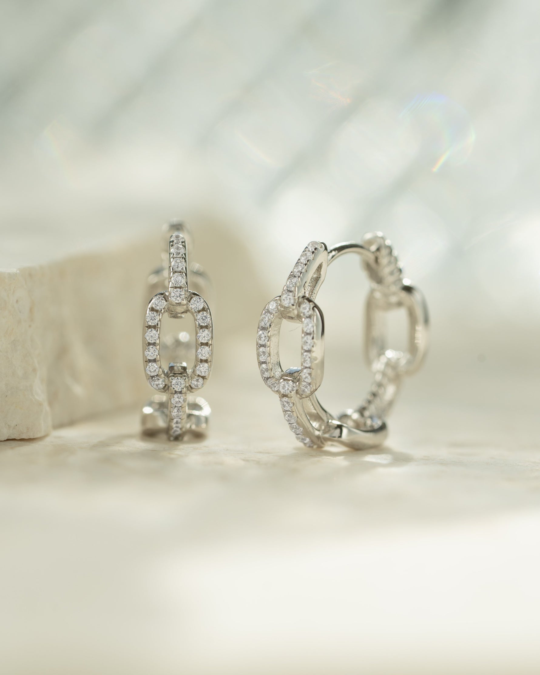 Sterling silver small chain link hoop earrings by Sami Jewels, showcasing a delicate, interconnected link design.