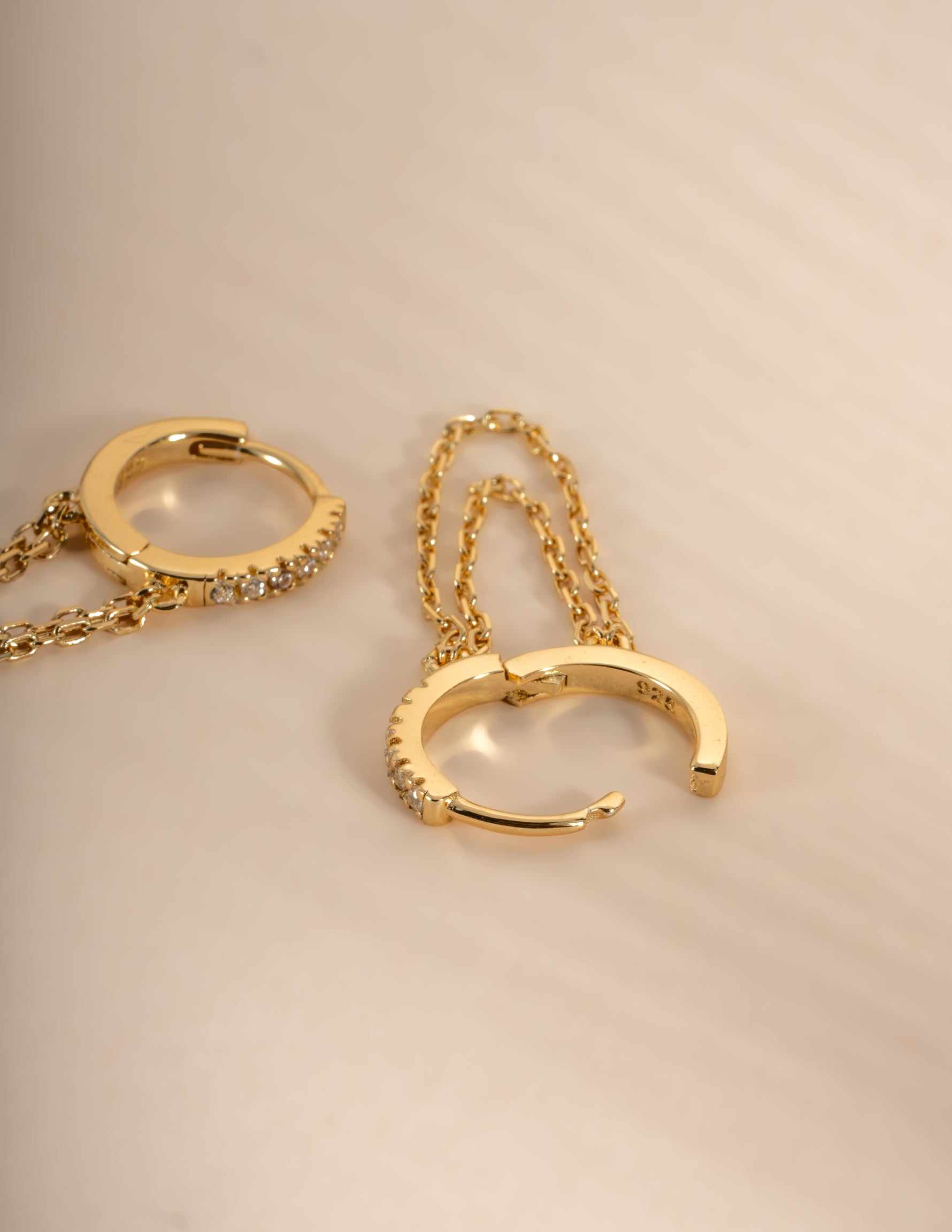 Gold chain link huggie earrings with latch back closure by Sami Jewels, close-up view showing detailed design and polished finish.