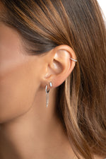 Sterling silver chain link huggie earrings by Sami Jewels, close-up view showing textured metal and secure hinge closure.