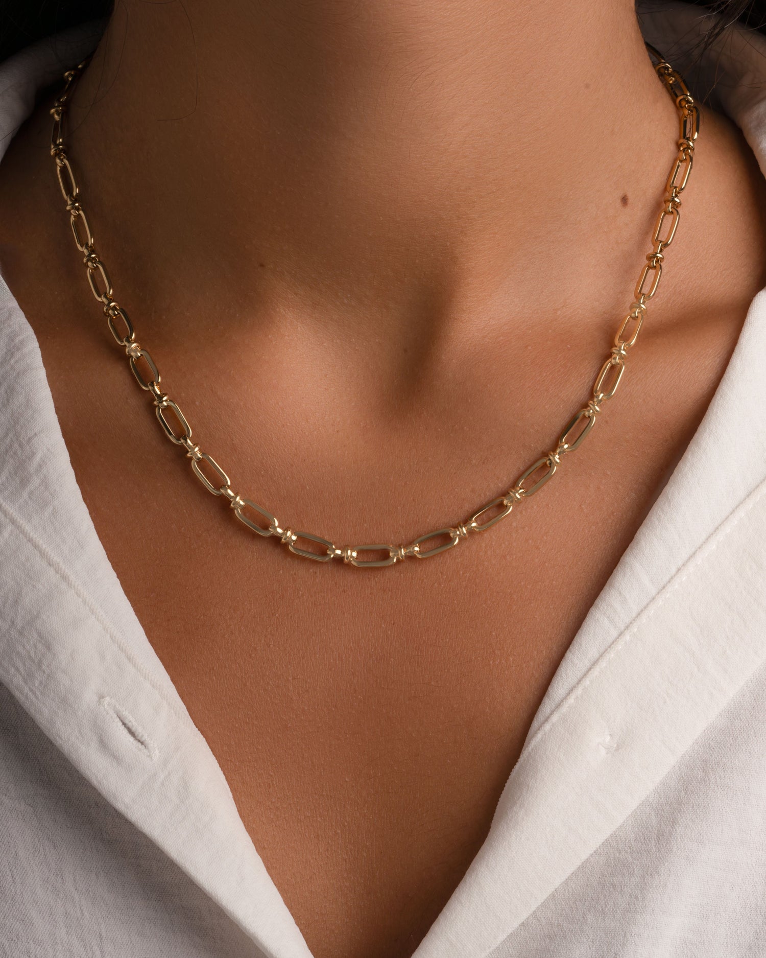 Gold chain link necklace from Sami Jewels featuring interlocking links on a model.
