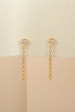 Close-up of gold chain stud earrings by Sami Jewels, showcasing their sleek design and polished finish.