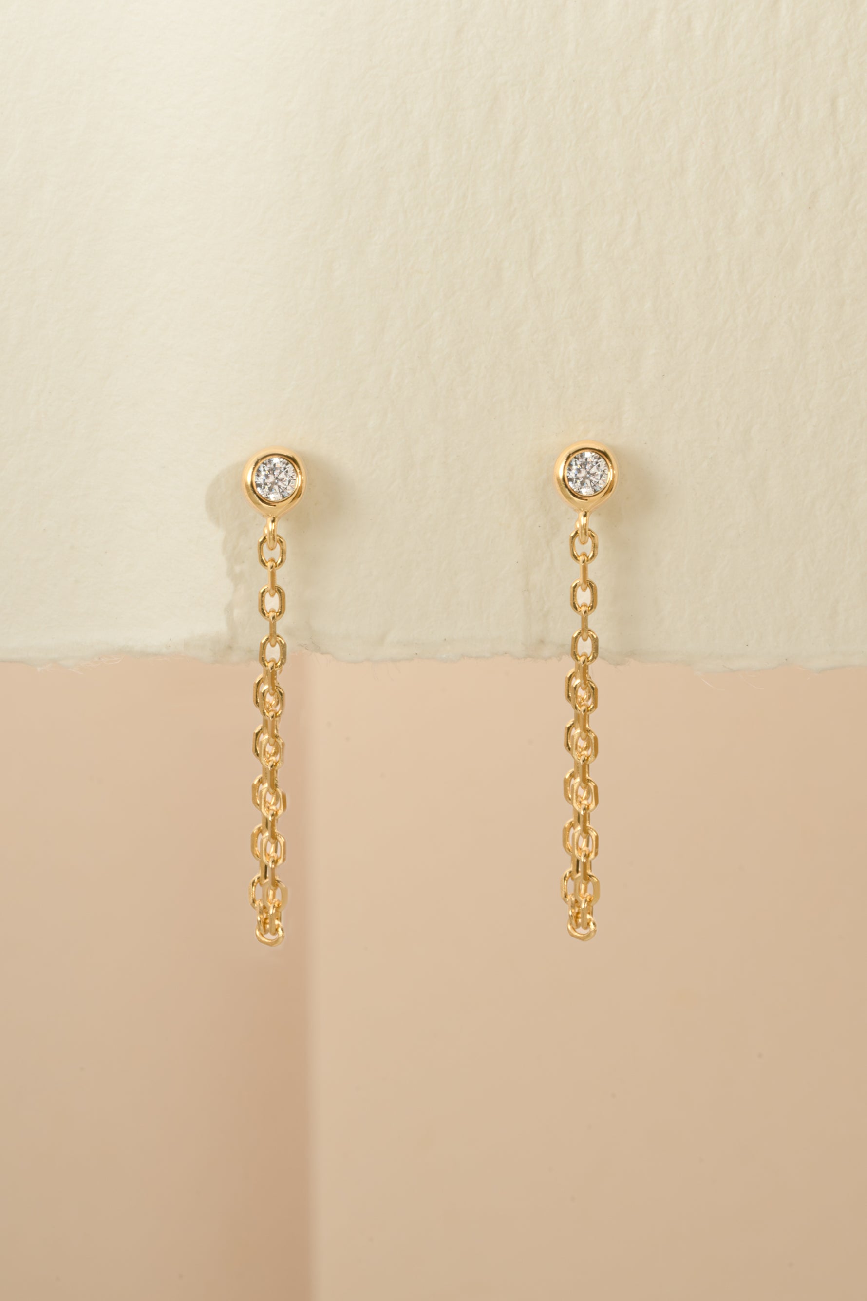 Close-up of gold chain stud earrings by Sami Jewels, showcasing their sleek design and polished finish.