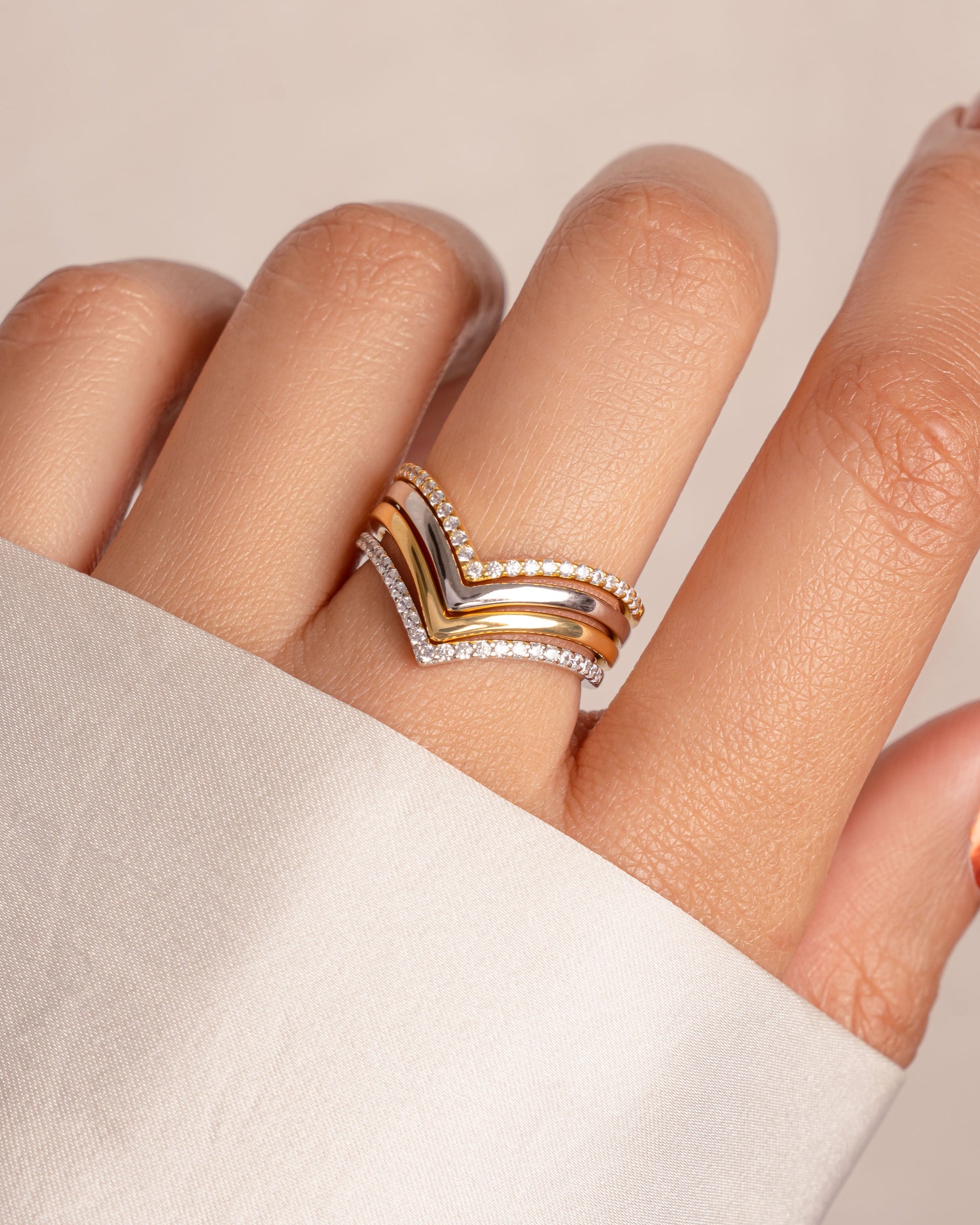 Gold and sterling silver Chevron ring set by Sami Jewels featuring geometric V-shaped designs on multiple rings.