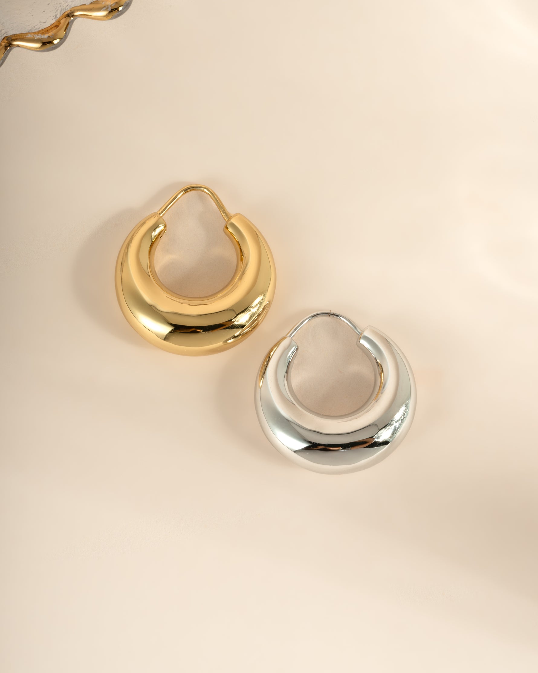 Gold and silver chunky basket hoop earrings from Sami Jewels, featuring bold, textured metal design for a stylish look.