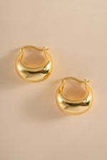 Gold chunky basket tube hoop earrings from Sami Jewels shown in side profile, showcasing their bold, textured design.