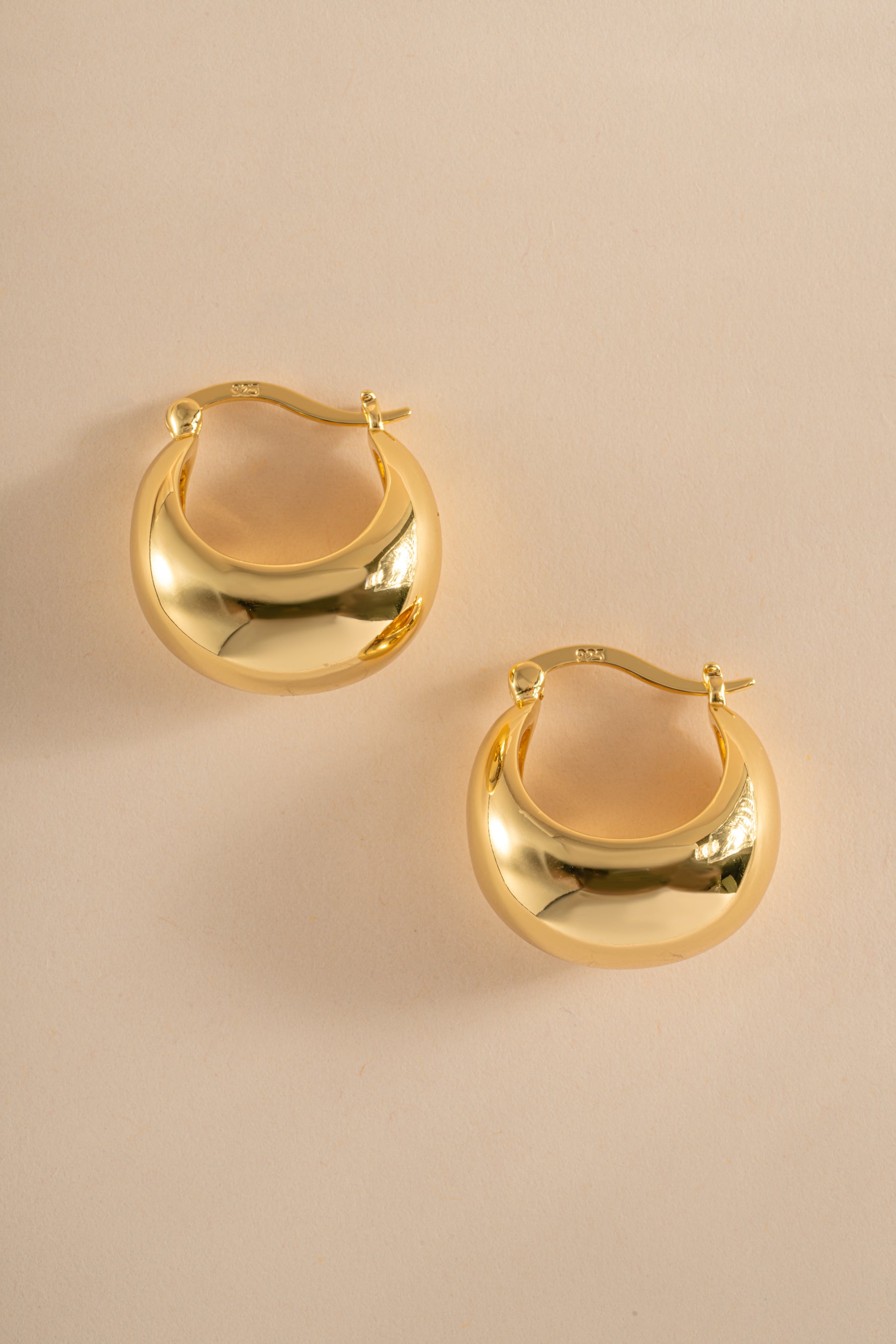 Gold chunky basket tube hoop earrings from Sami Jewels shown in side profile, showcasing their bold, textured design.